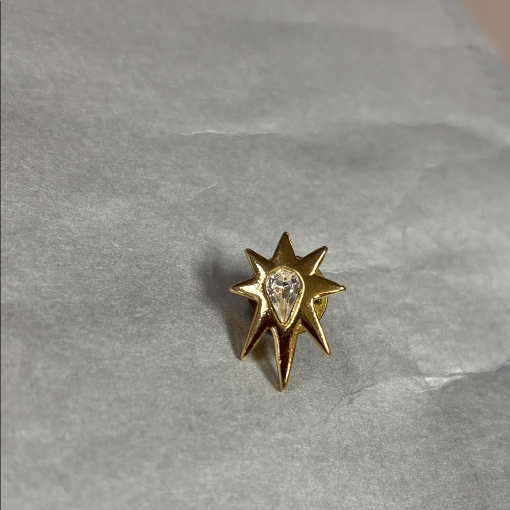 Radiant Gold Starburst Brooch with Crystal Center